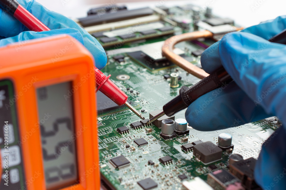 Fotografie IT technician repairing broken laptop notebook computer