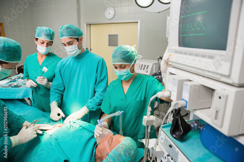 Surgical team next to a monitor