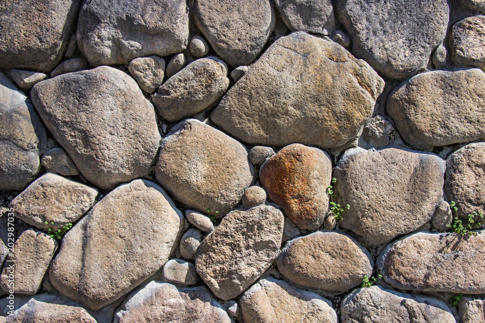 Texture of old stacked stone wall have grass along the rock. Texture of old stacked stone wall have grass along the rock.
