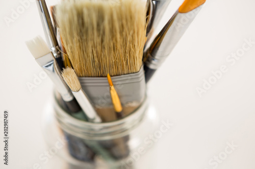 Close-up of various paintbrush in a jar