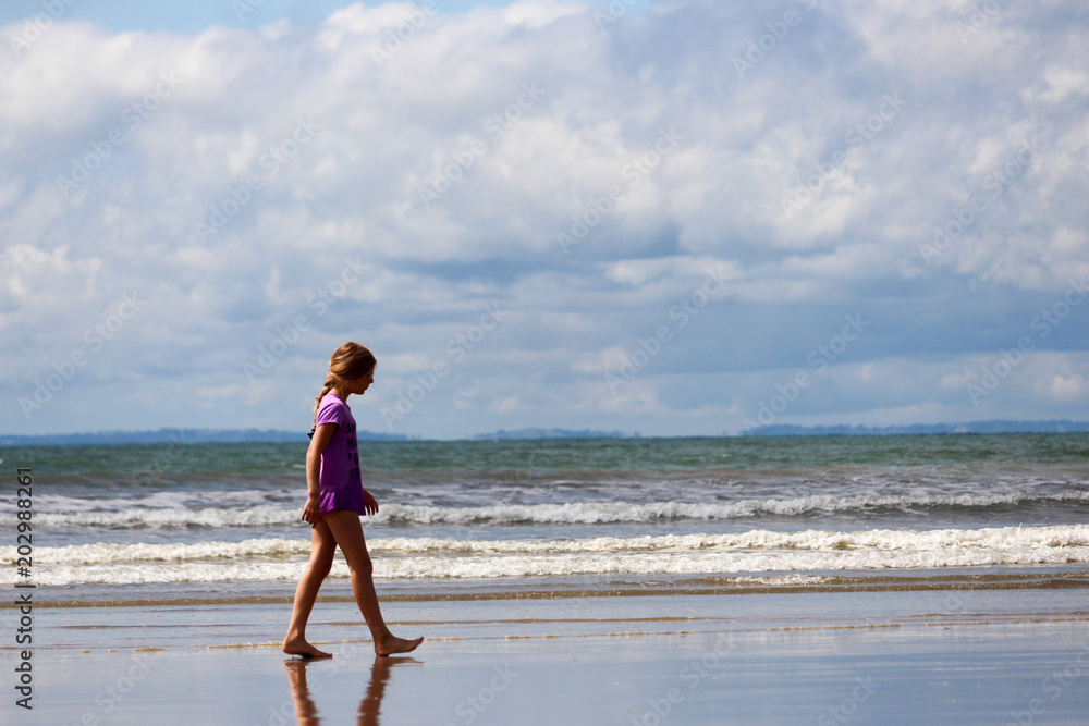 Girl on beach with reflections