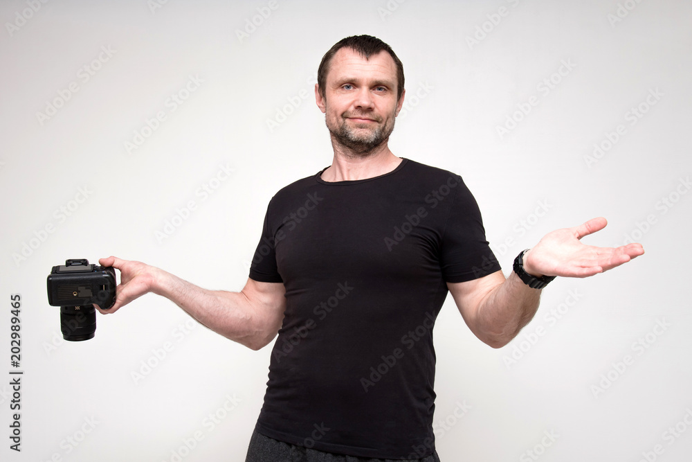 Portrait of a pretty photographer on a white background, satisfied with the picture. Portrait of a pretty photographer on a white background, satisfied with the picture.