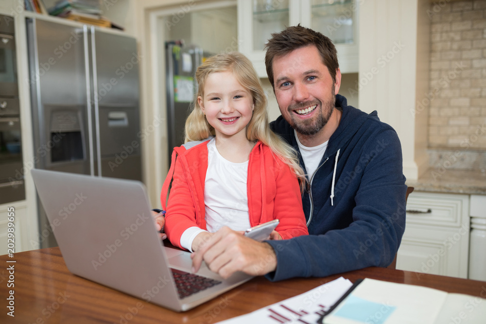 Father and daughter working on laptop Father and daughter working on laptop