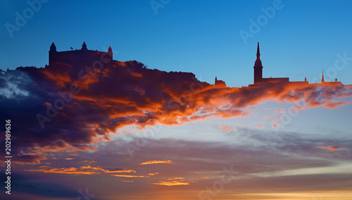 The symbolic silhouette of Bratislava in sanstet clouds.