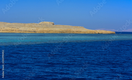 Elevated above sea level, beautiful coral reefs the form mountains and rocks against the blue sky and clear sea water coast of the unique Ras Mohammed nature reserve. Magnificent diving, summer, rest. photo