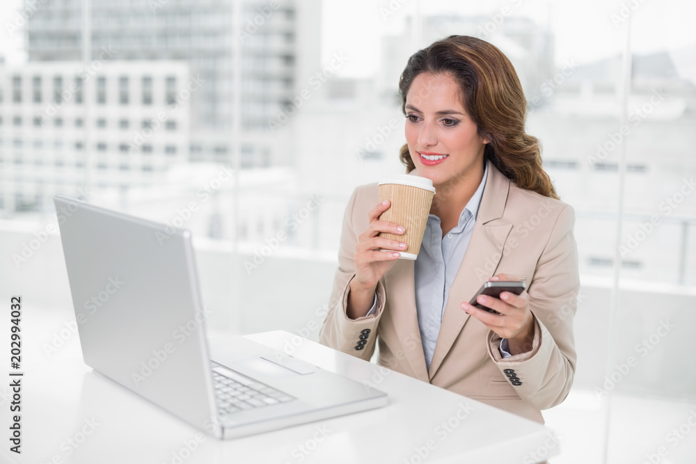Happy businesswoman holding disposable cup and smartphone Happy businesswoman holding disposable cup and smartphone