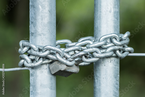 Strong iron chain and padlock, green background