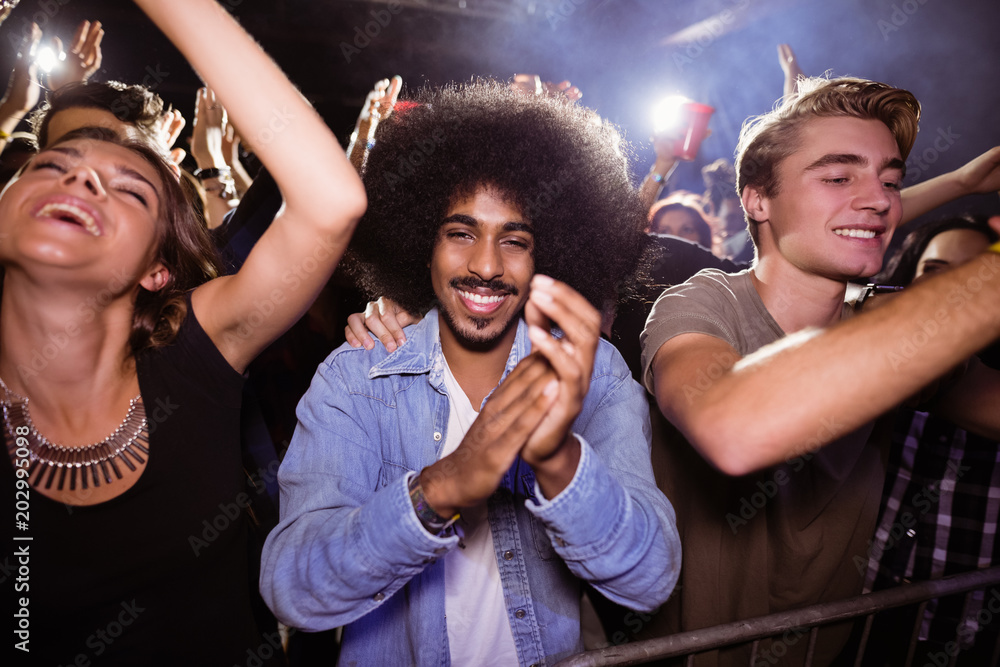Portrait of man amidst crowd at nightclub