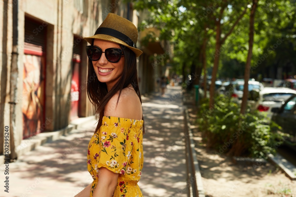 Happy young woman on the street outdoor in summer