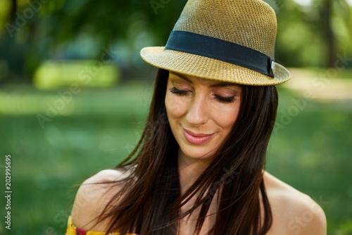 Happy young woman in the park outdoor in summer