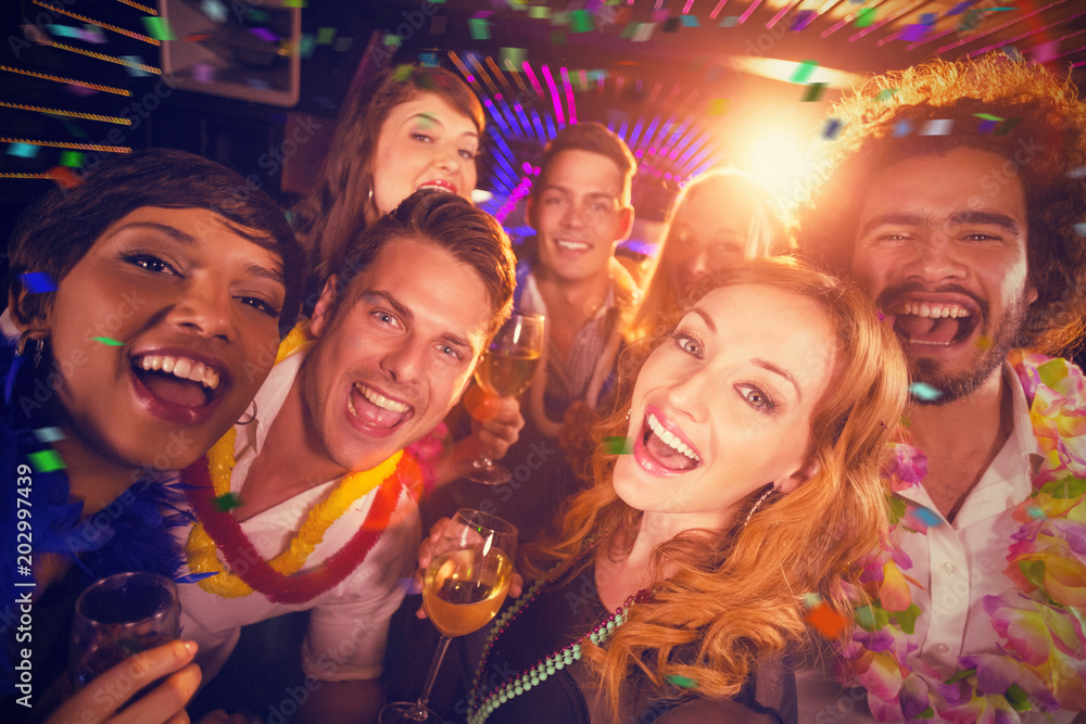 Group of friends having fun in bar against flying colours