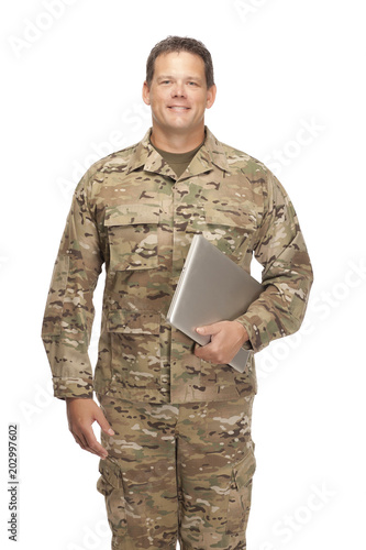 U.S. Army Soldier, Sergeant. Isolated and holding laptop.
