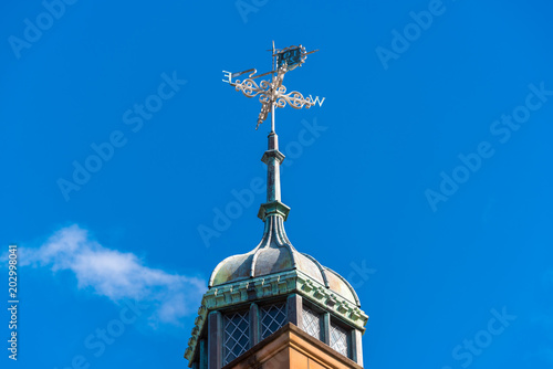 Vintage weatherclock on top of old building photo