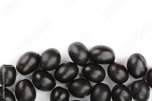 whole black olives isolated on white background with copy space for your text. Top view. Flat lay pattern