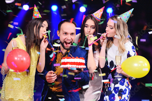 a guy and three girls rejoice and celebrate the party in the night club. Birthday, new year, corporate party, best friends