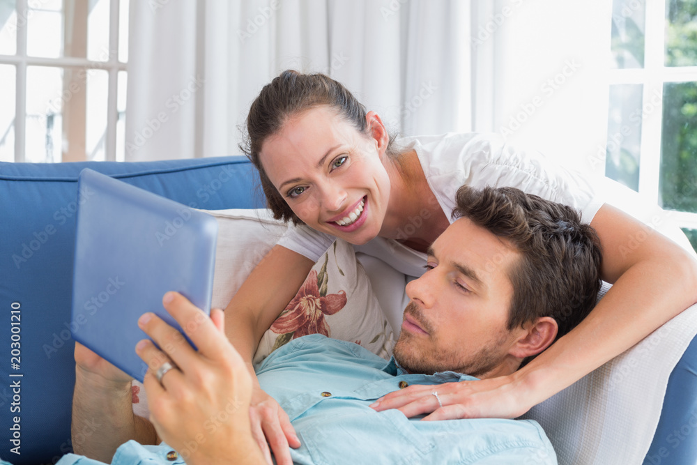 Fototapeta premium Loving couple reading book on couch