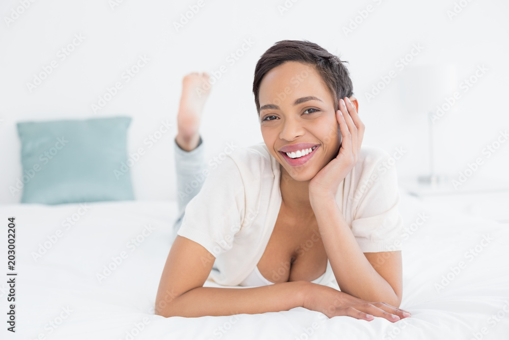 Smiling pretty young woman relaxing in bed Smiling pretty young woman relaxing in bed