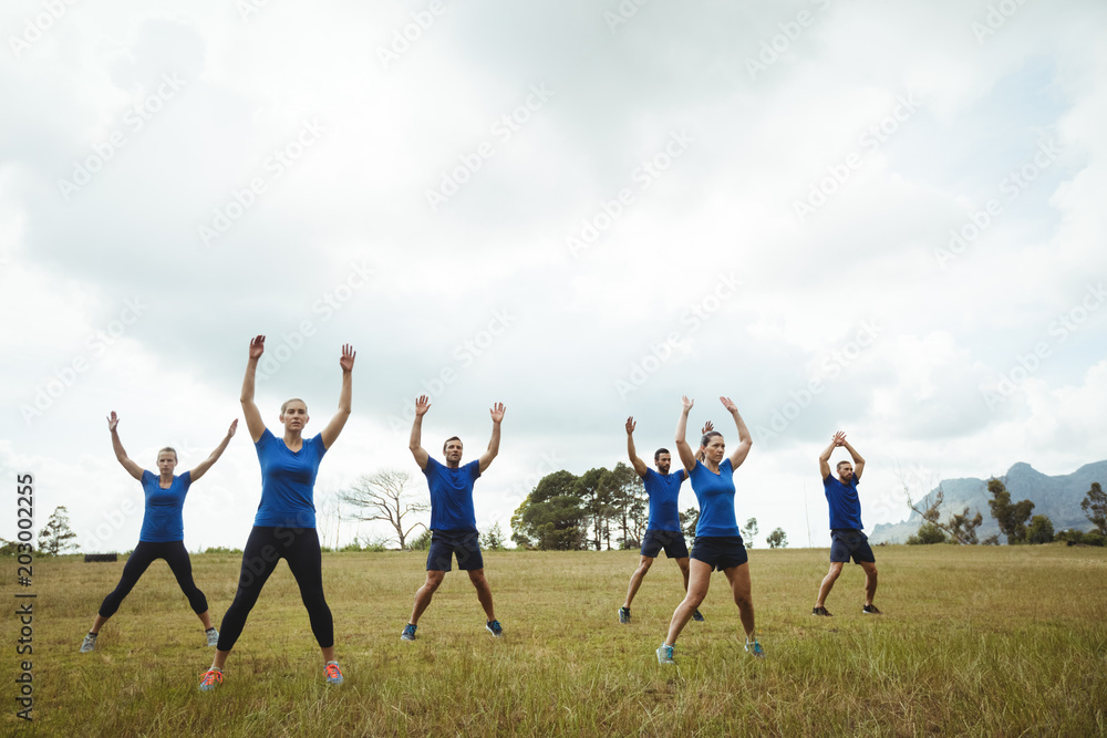 Fototapeta premium Fit people performing stretching exercise
