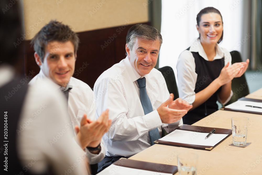 Business people clapping after a presentation Business people clapping after a presentation