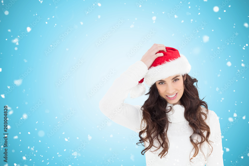 Confused brunette in santa hat against blue vignette Confused brunette in santa hat against blue vignette