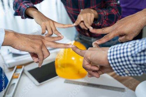 Businessman and engineer people group making stars mark by finger showing teamwork, successful and unity of team
