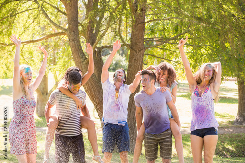 Young friends having fun with hose in the park