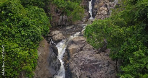 AERIAL 4K: . Flying Along mountain Waterfall and Rainforest. Aerial camera shot. Thailand,koh Phangan island,Than Sadet waterfall area photo