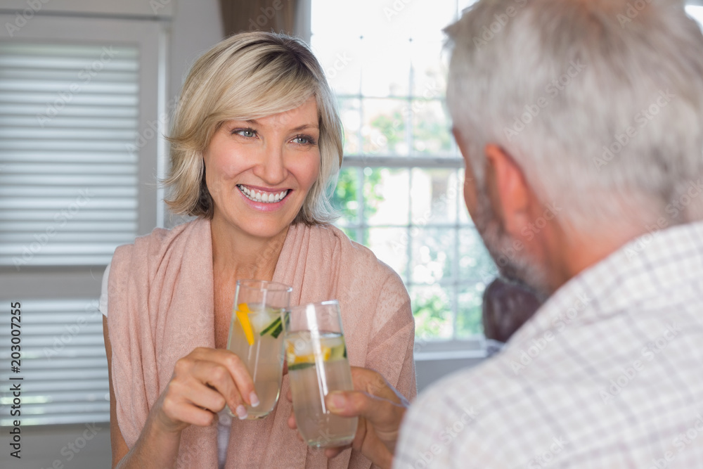 Couple toasting drinks at home Couple toasting drinks at home