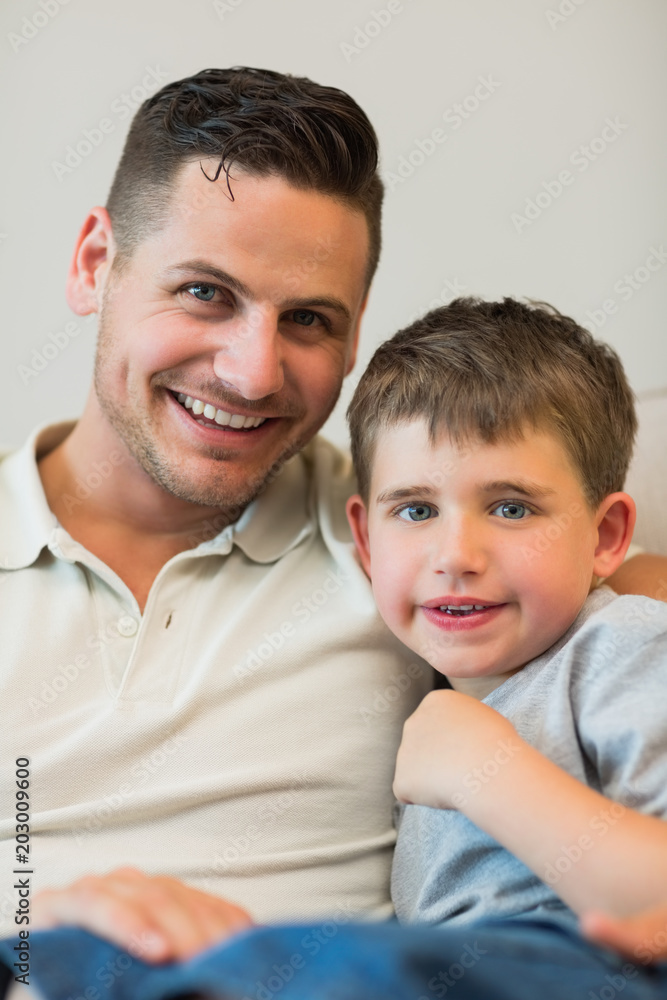 Father and son smiling together at home Father and son smiling together at home