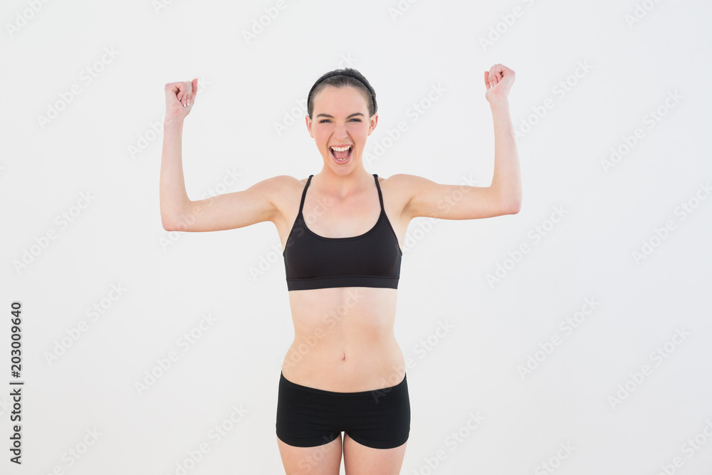 Sporty fit woman clenching fists against wall Sporty fit woman clenching fists against wall