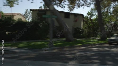 Right Side view of a Driving Plate: Car turns left from South Oak Knoll Avenue in Pasadena, California, and travels through affluent neighborhood on Old Mill Road, passing over speed bumps. photo