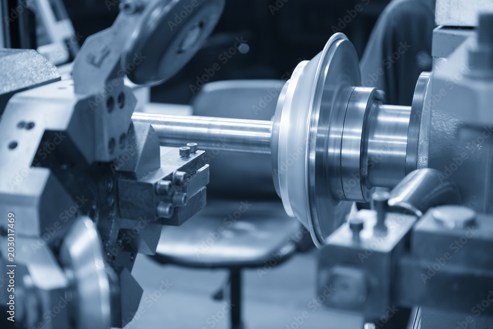 The CNC spinning machine forming the aluminum plate to the cone shape ...
