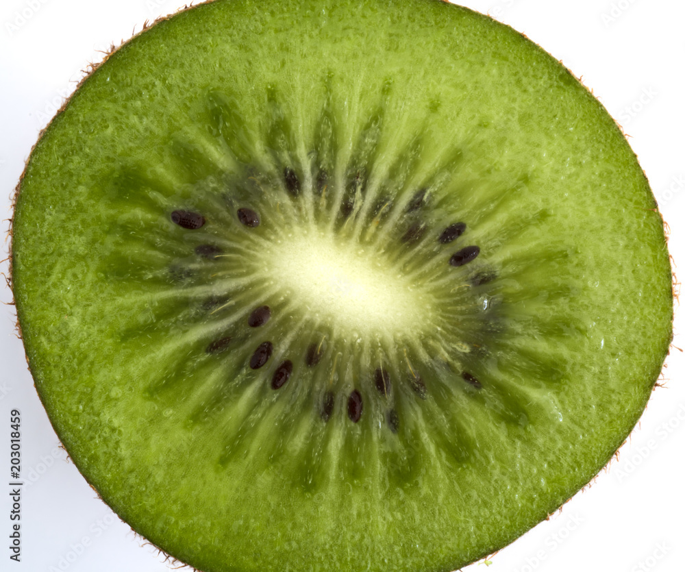 Macro view of a Kiwi cut in half isolated on white background