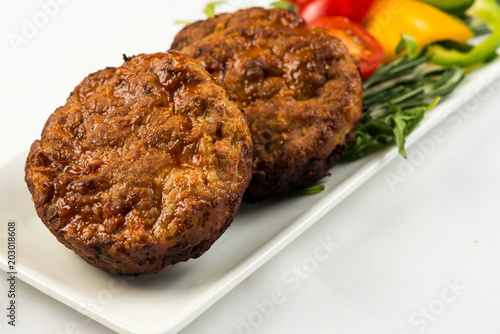 Fried cutlets and vegetable salad white plate on white background