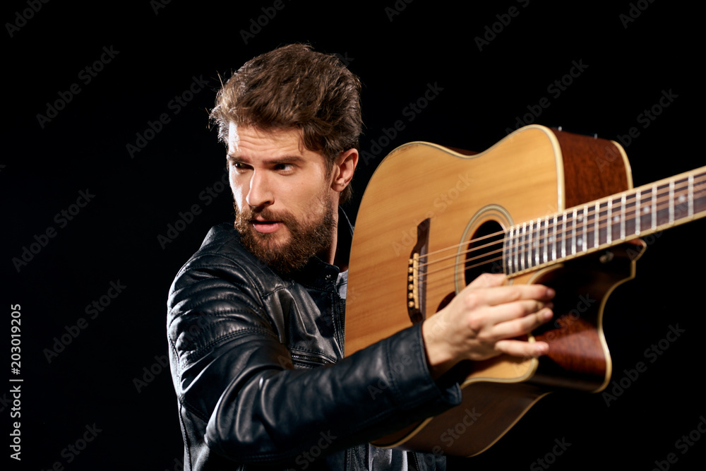 young man playing acoustic guitar