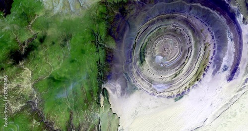 Very high-altitude overflight aerial of the Richat Structure in the Maur Adrar Desert, Mauritania. Clip loops and is reversible. Elements of this image furnished by USGS/NASA Landsat