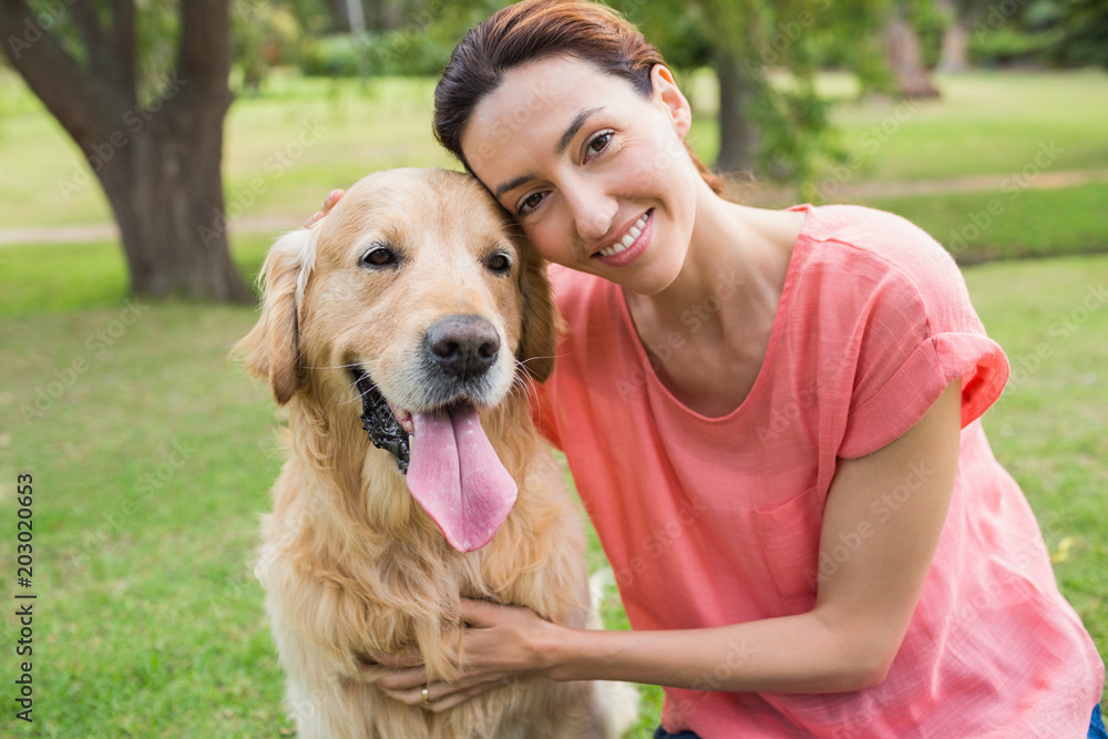 Pretty brunette looking at camera with her dog Pretty brunette looking at camera with her dog