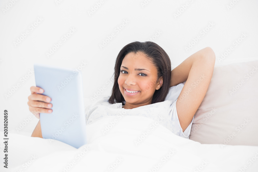 Content young dark haired model holding a tablet pc Content young dark haired model holding a tablet pc