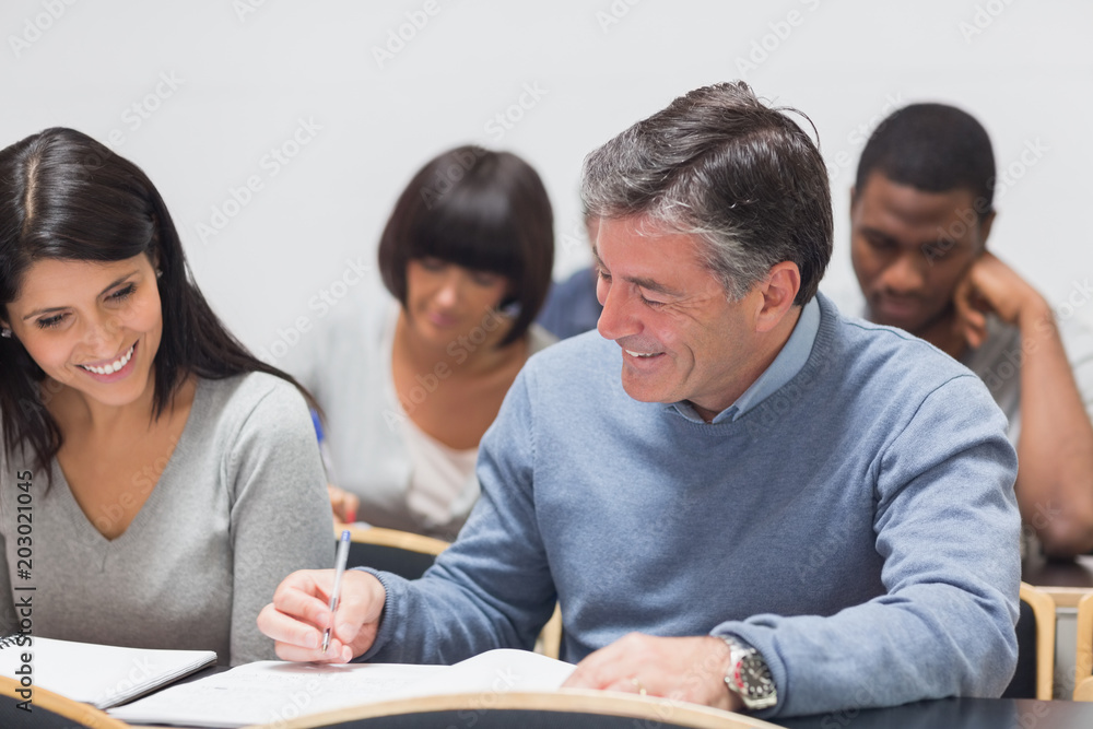 Man and woman talking during lecture Man and woman talking during lecture