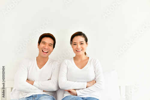 A couple loves playing in the happily bedroom.