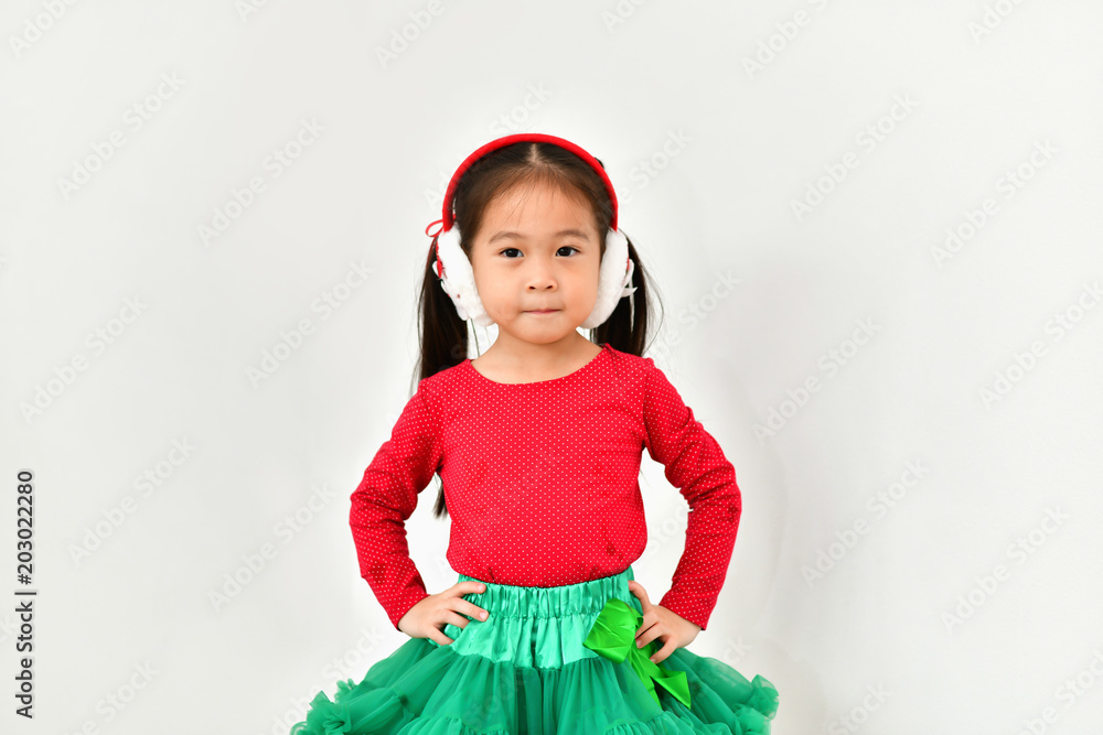 Little girl celebrates Christmas with red Santa dress. Little girl celebrates Christmas with red Santa dress.