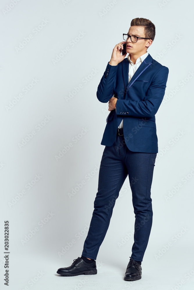 young man talking on the phone isolated on white young man talking on the phone isolated on white