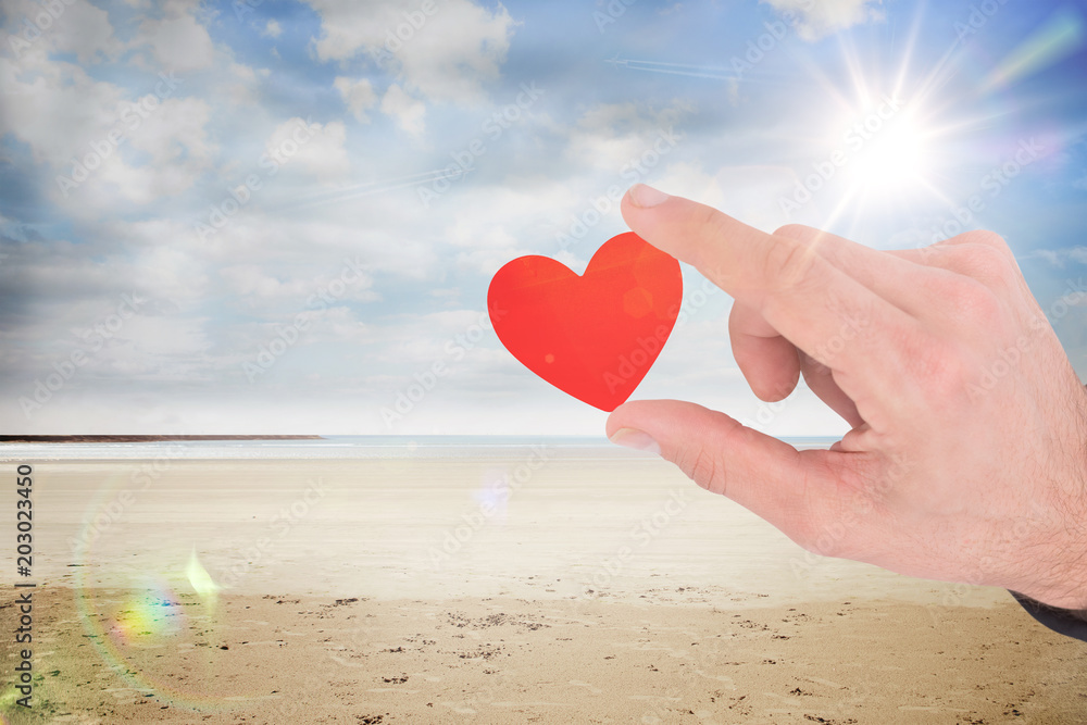 Fototapeta premium Businessman measuring something with these fingers against serene beach landscape