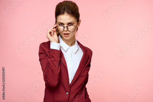 business woman with glasses on a pink background