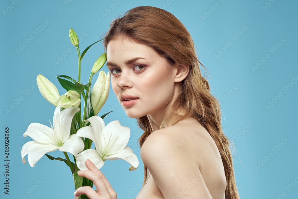 woman with lily over blue background woman with lily over blue background