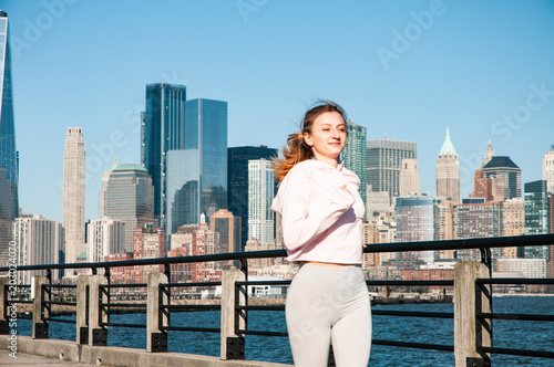 Run in the city. Woman is running in Liberty State Park