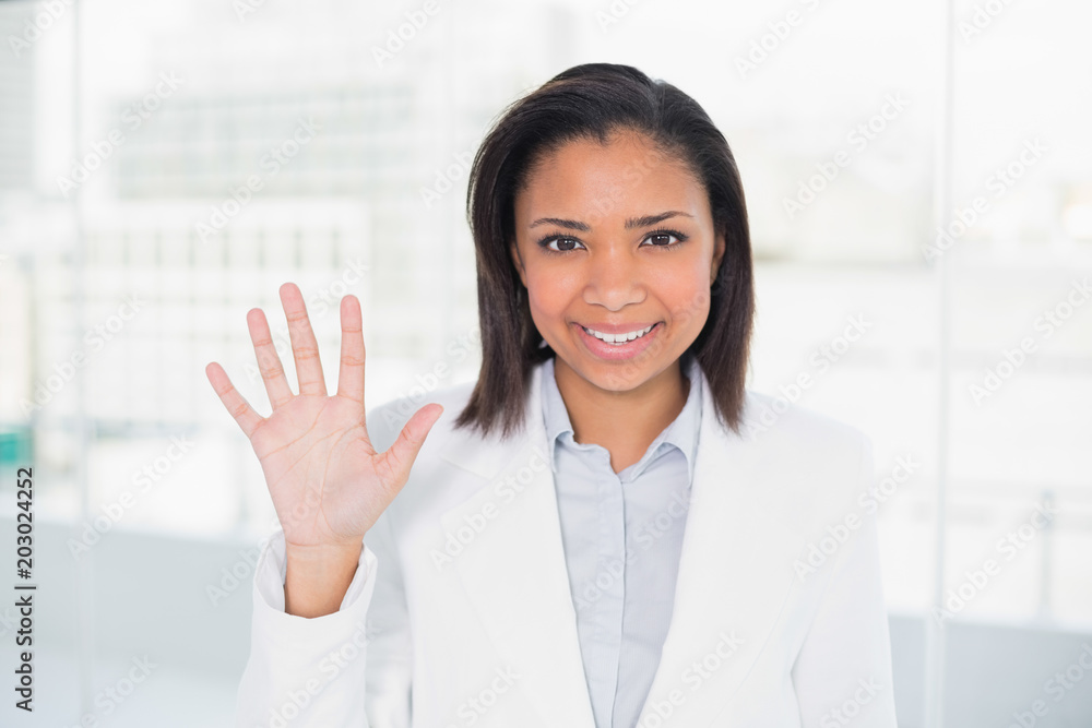 Pretty young dark haired businesswoman waving her hand Pretty young dark haired businesswoman waving her hand