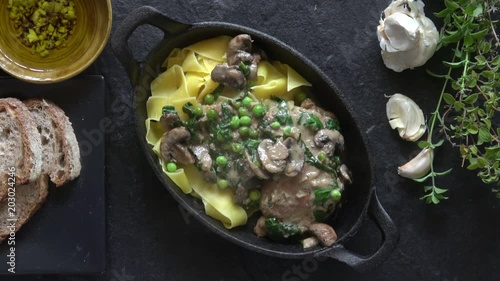 Chicken Marsala with Egg Noodles, Mushrooms, and Peas. A Traditional American-Italian Pasta Dish similar to a Stroganoff. Prepared and Served in a Cast Iron Skillet. photo