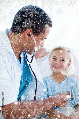 Attractive doctor checking the pulse on a young patient against snow falling