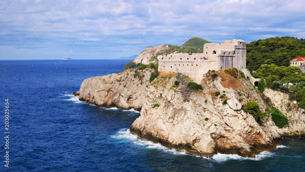 Waves crashing on Fort Lovrijenac’s promontory guarding Dubrovnik’s entrance over the Adriatic, with clouds on the background / Dubrovnik, Dubrovnik-Neretva, Croatia. Shot with RED Weapon Helium 8K. Waves crashing on Fort Lovrijenac’s promontory guarding Dubrovnik’s entrance over the Adriatic, with clouds on the background / Dubrovnik, Dubrovnik-Neretva, Croatia. Shot with RED Weapon Helium 8K.